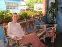 Ashe relaxing on the 2nd floor patio at our hotel (Hotel RamuÂ´s) in Quepos.